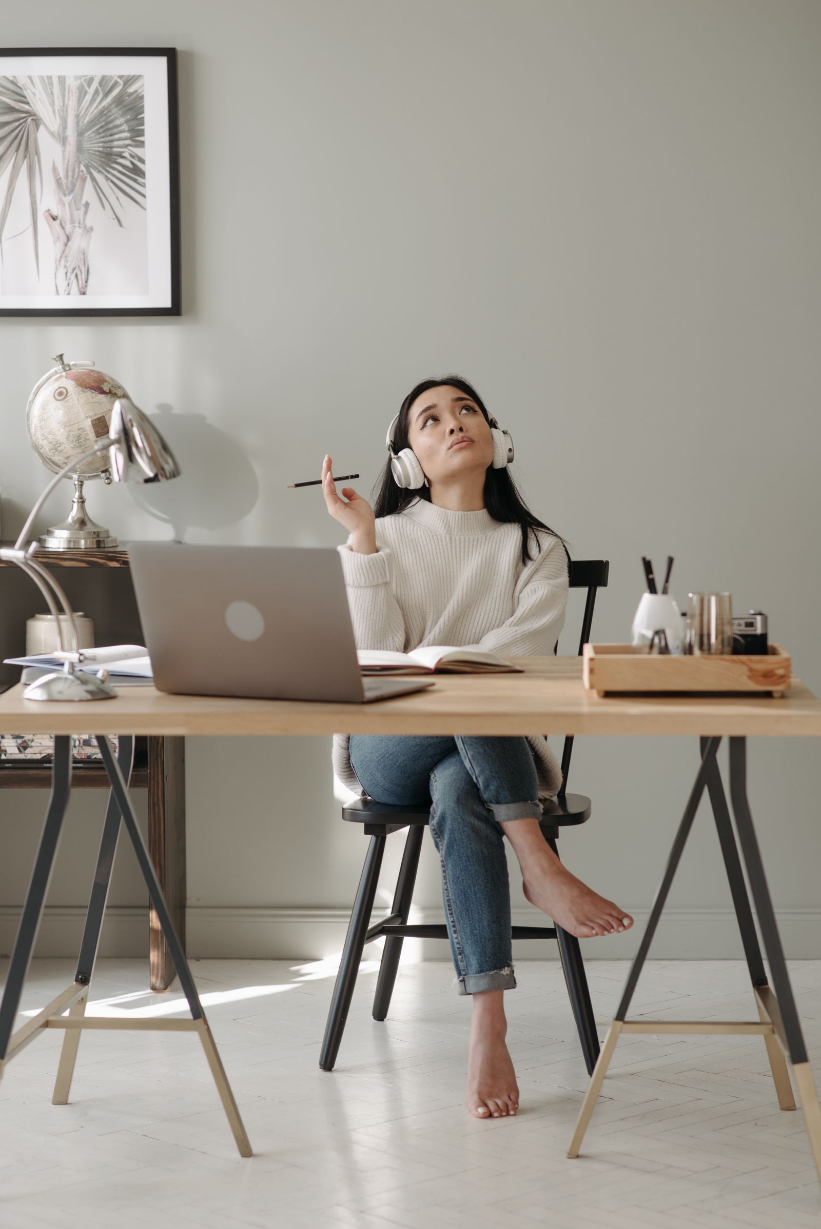 Listener wearing headphones at a home desk