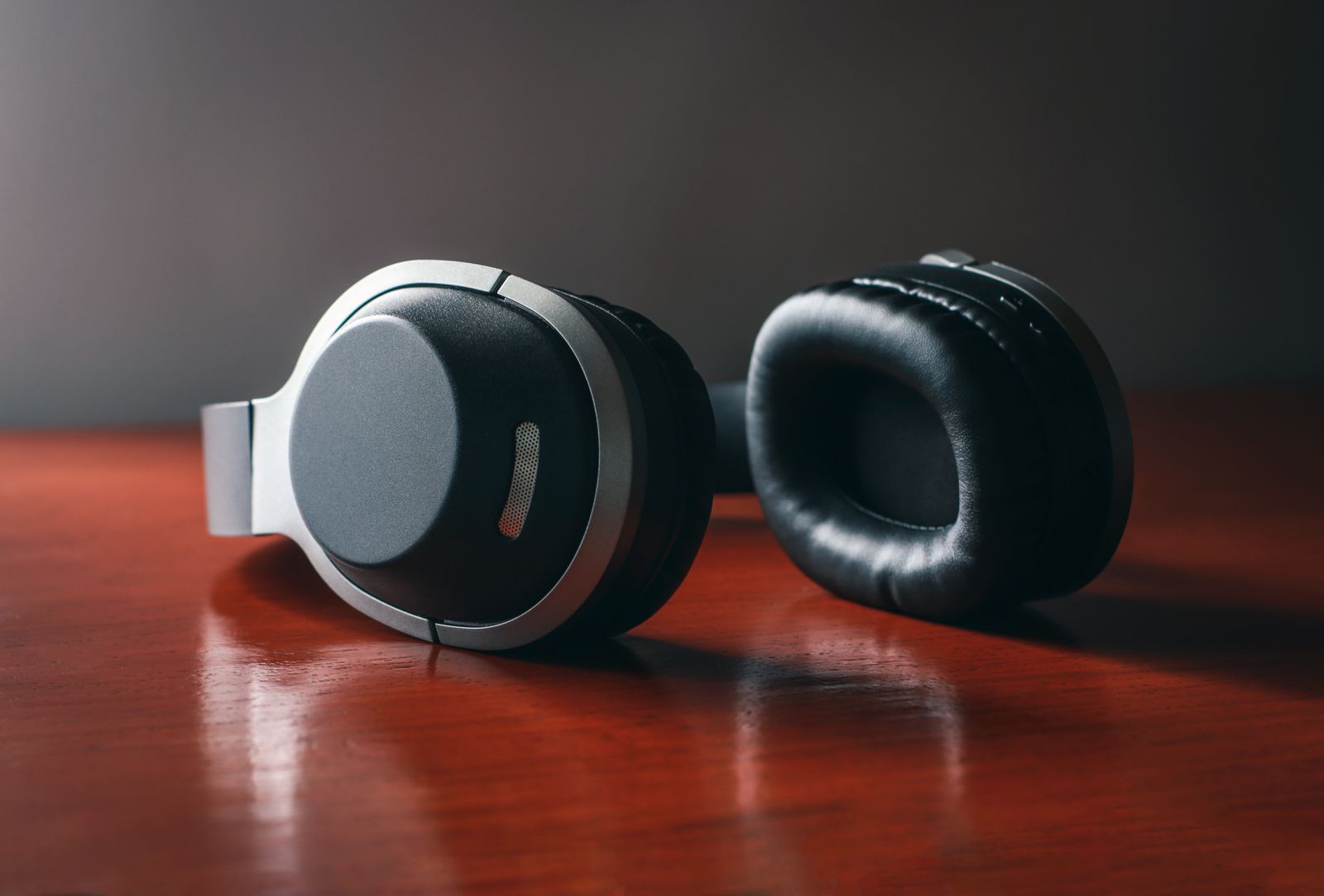 Padded headphones resting on a wooden surface
