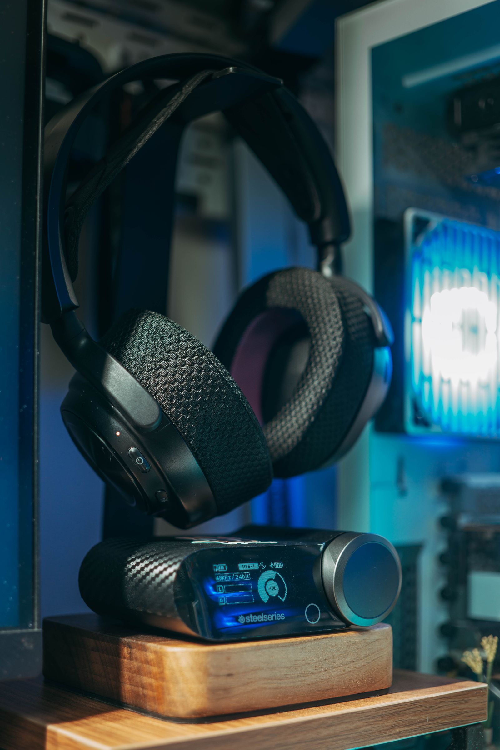 Headset beside a compact desktop audio controller