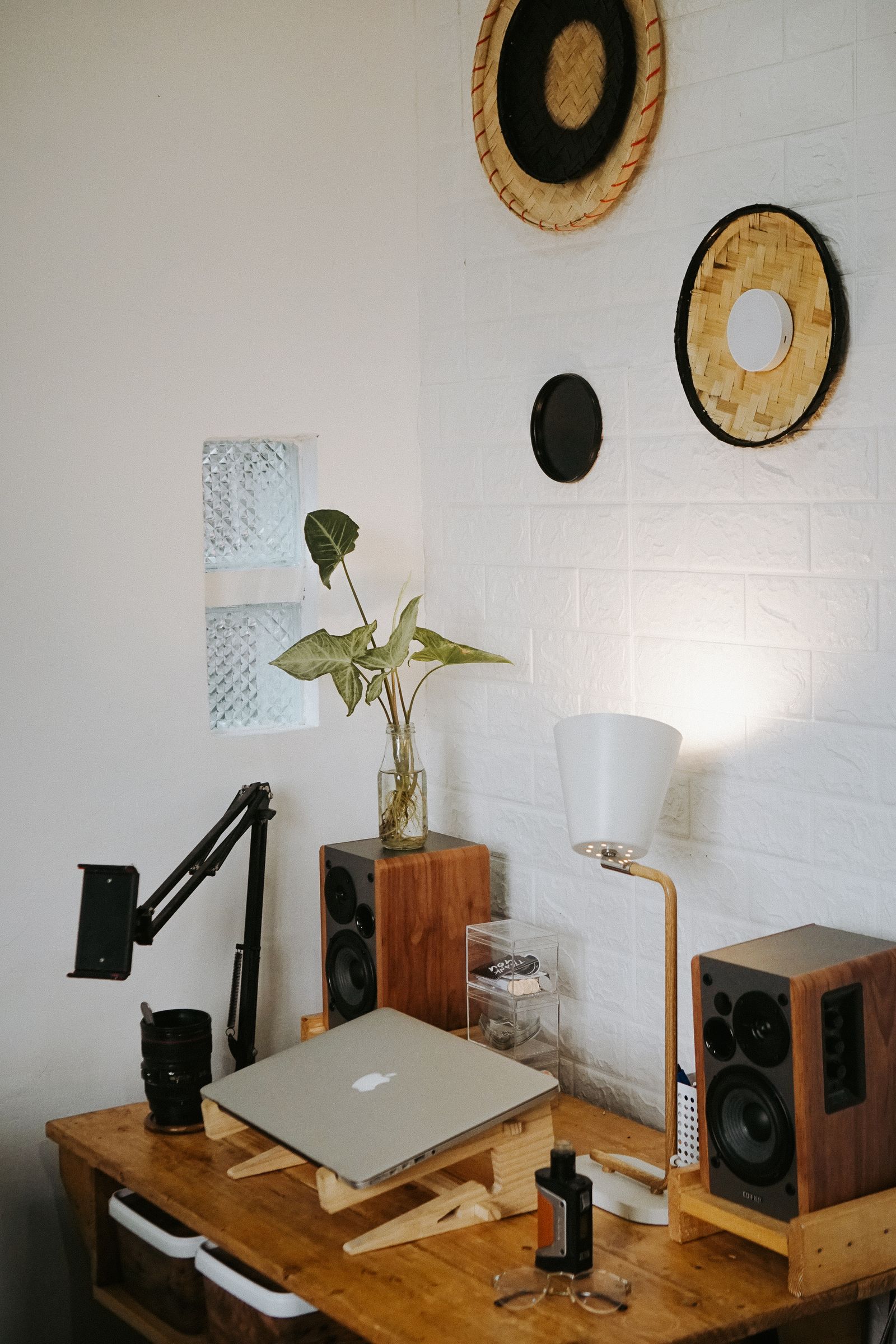 Small speakers beside a laptop in a home workspace