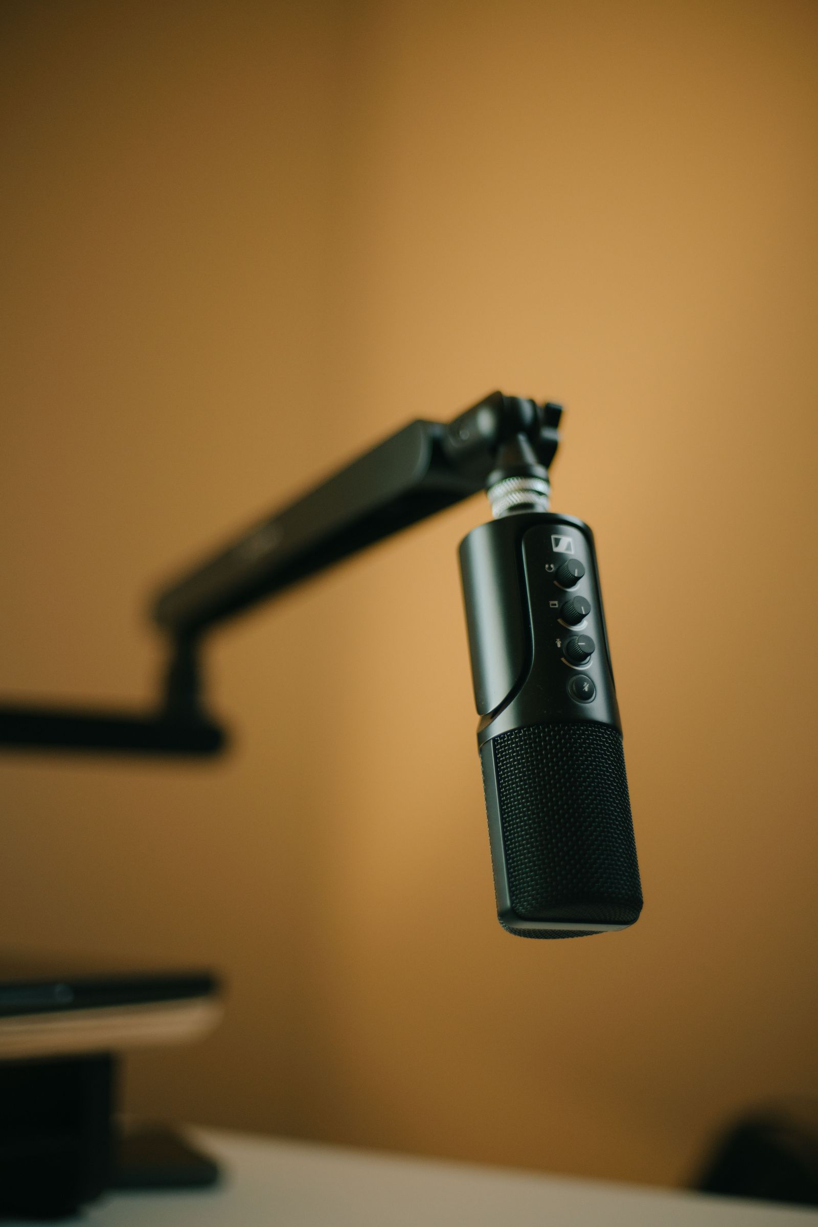 Microphone hanging from an adjustable boom arm