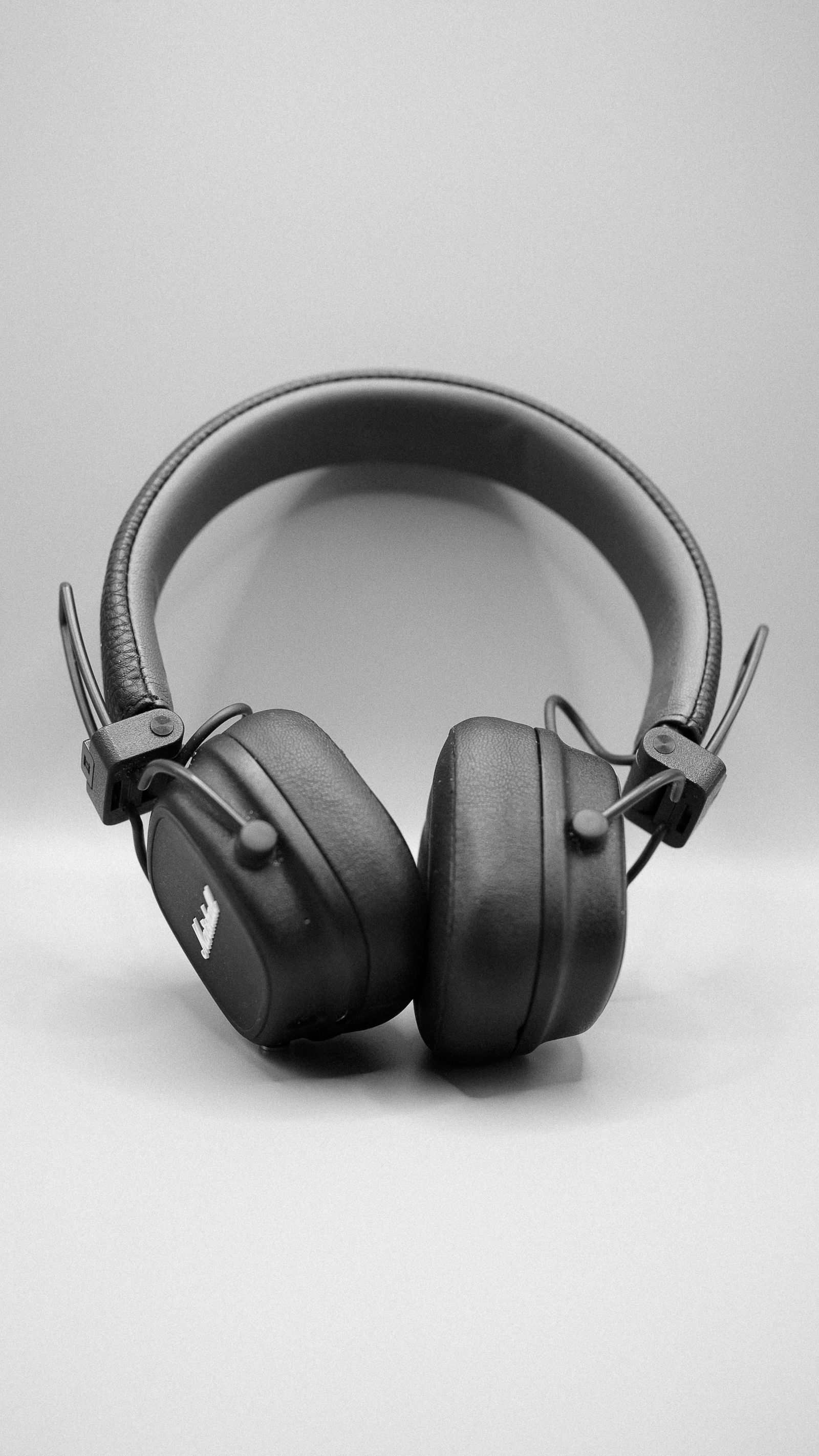 Black over-ear studio headphones against a light background