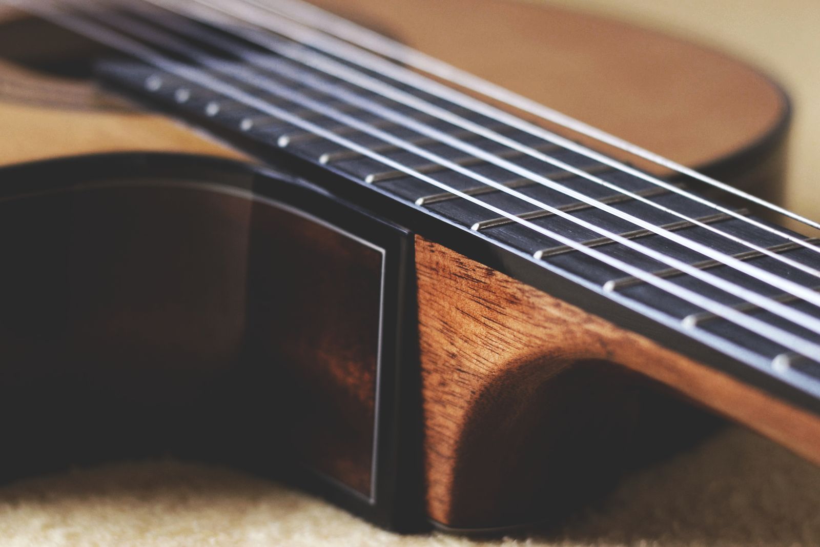 Close view of classical guitar strings and fretboard