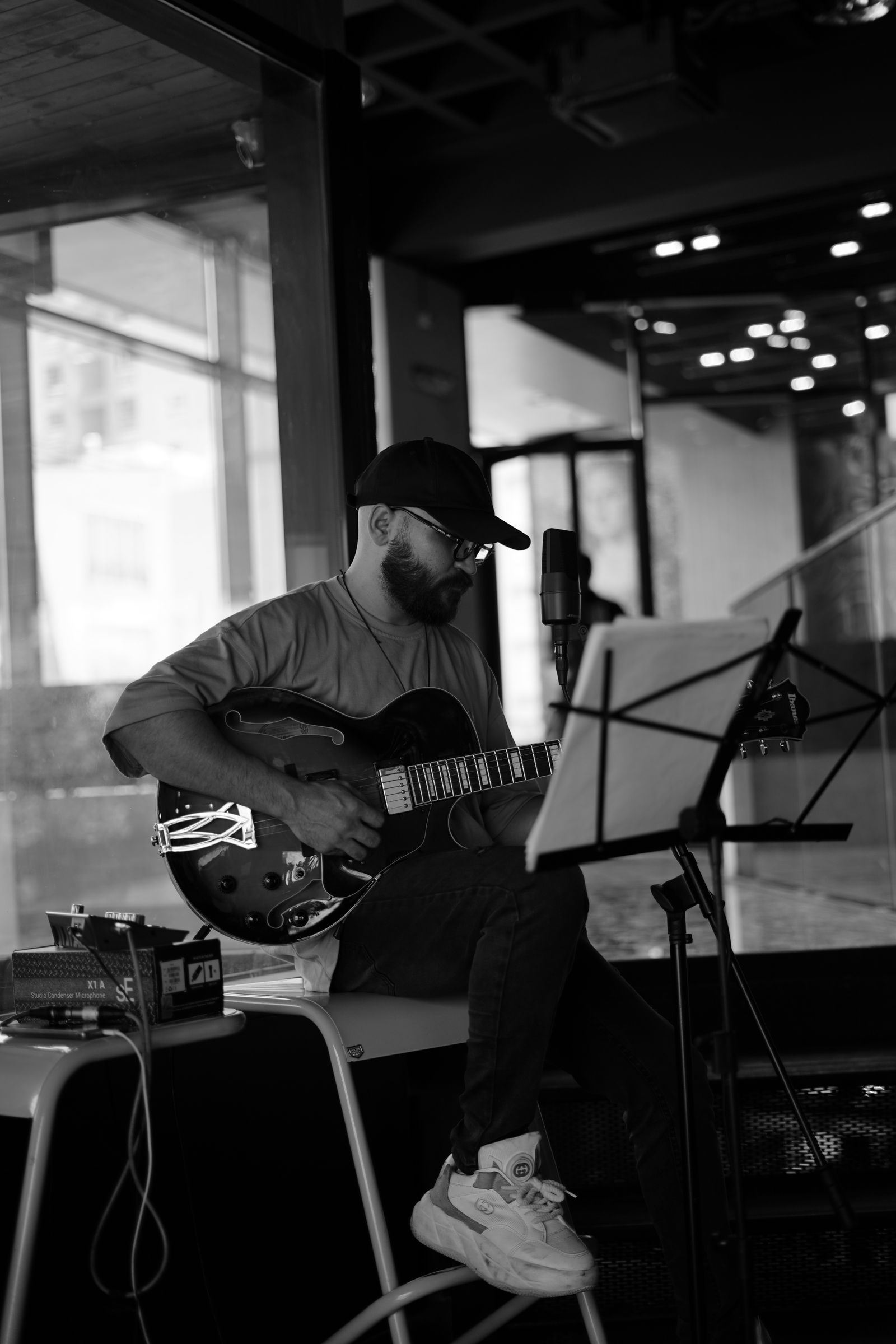 Musician playing electric guitar indoors