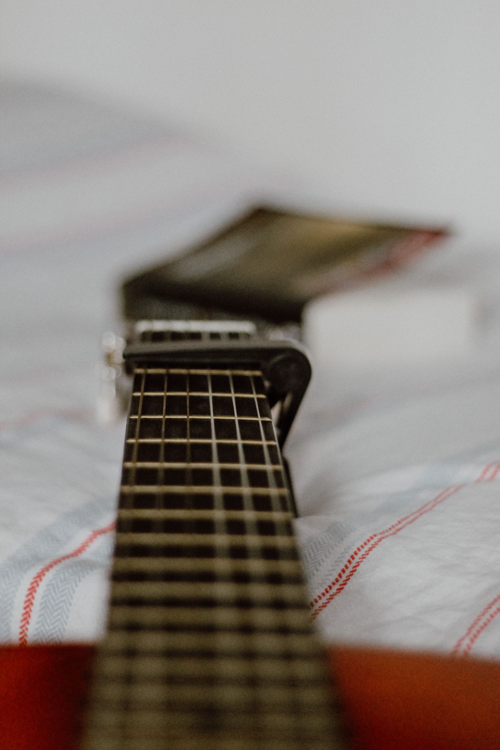Capo attached to an acoustic guitar neck