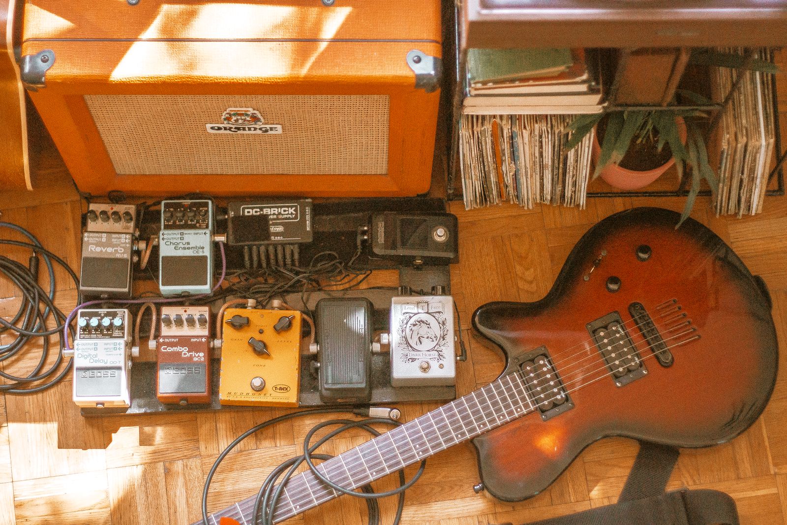 Effects pedals arranged beside an electric guitar