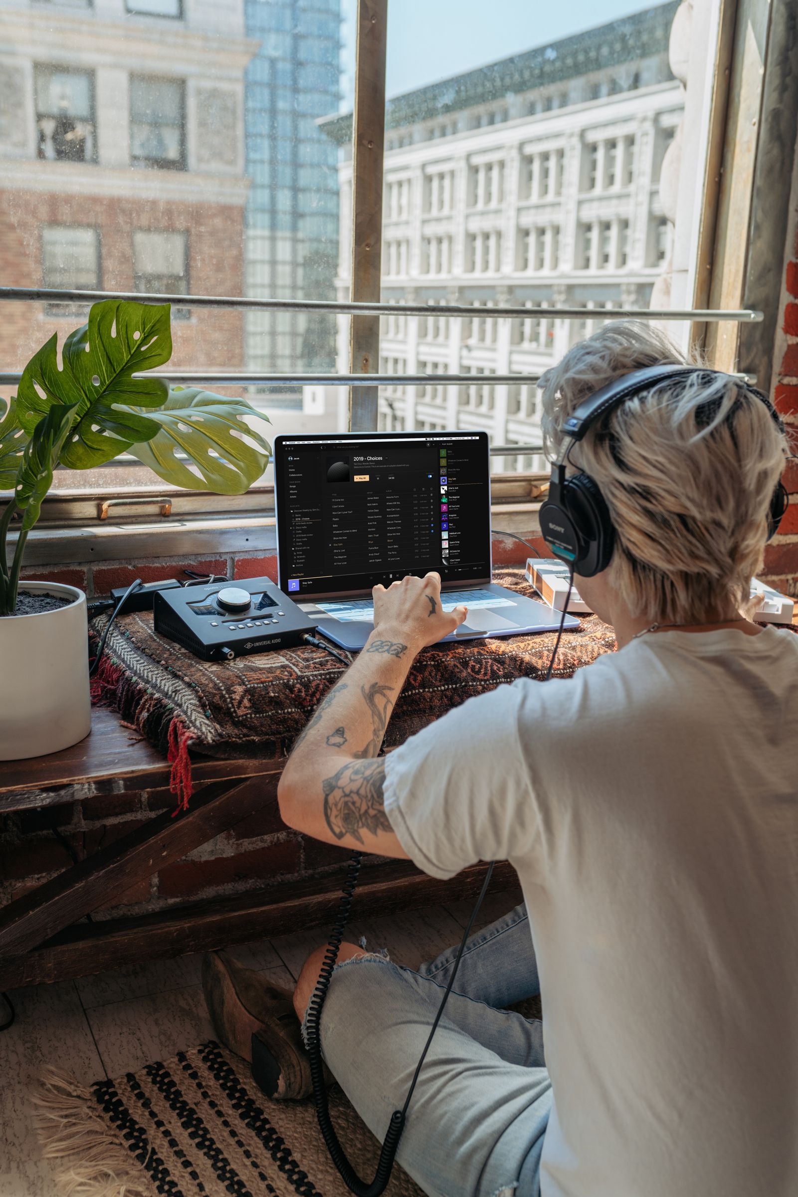 Musician working on a laptop music session