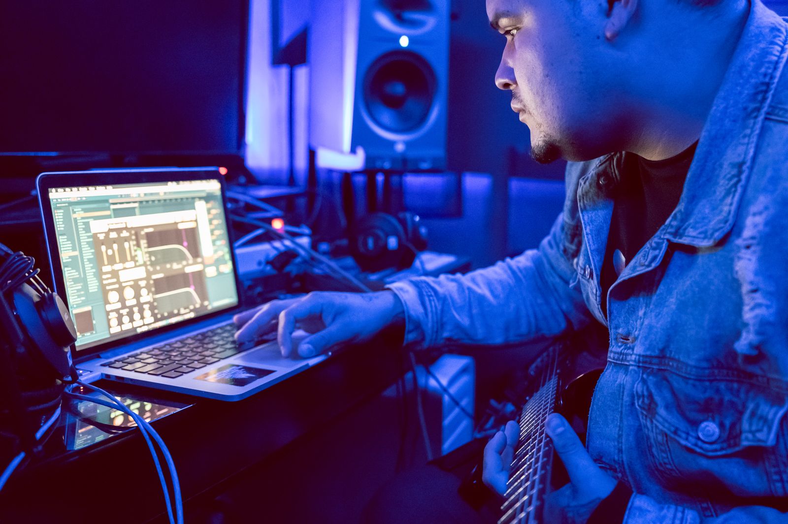 Laptop session open beside studio equipment